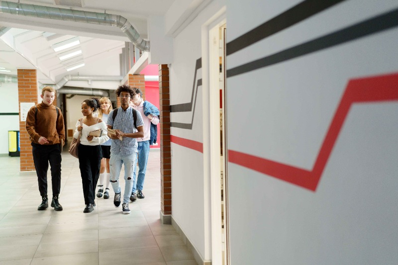 Students walking on their college campus.  